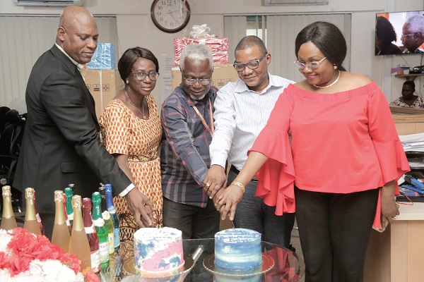 Mr Kingsley Inkoom (middle) and Ms Salome Donkor (2nd left) joined by Mr Ato Afful (left), Mrs Mavis Kitcher (right) and Mr Kobby Asmah to cut their cakes.