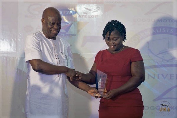 Mr William Addy (left), Revenue Protection Manager of ECG, presenting the award to Mrs Mary Anane-Amponsah