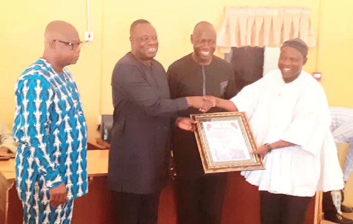 Dr Awal (2nd left), receiving the citation from Mr Saeed. Looking on are Mr Salifu and Mr Sibdow, the Regional Secretary of the NPP