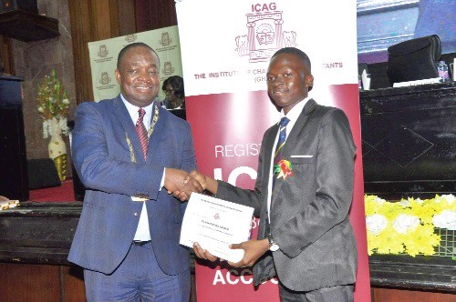 Prof. Kwame Adom-Frimpong (left), President, Institute of Chartered Accountants, Ghana, presenting the Overall Best Student Award to Mr Evans Tettey Odjer. Picture: NII MARTEY BOTCHWAY