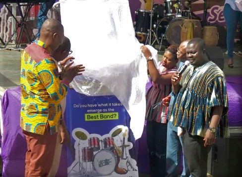 Mr Dwumfour (right), together with the Director at AMV, Mrs Margaret Tobbin Osei (3rd right), Dr Emmanuel Bortey Borketey (left), the CEO of Charger Limited, unveiling the banner at the launch of Kronkron season two