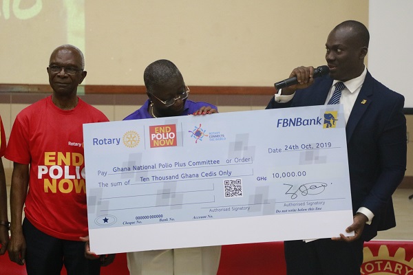 Mr Enoch Vanderpuije (right) donating a cheque to the Ghana National Polio Plus