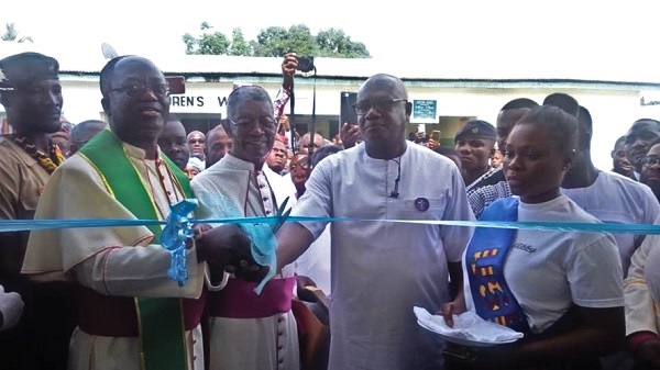 The Catholic Bishop of the Ho Diocese, Most Rev. Emmanuel Kofi Fianu (left), with Mr Prosper Bani (second right) cutting the tape to inaugurate the building (inset)