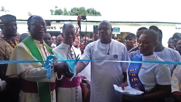 The Catholic Bishop of the Ho Diocese, Most Rev. Emmanuel Kofi Fianu (left), with Mr Prosper Bani (second right) cutting the tape to inaugurate the building (inset)