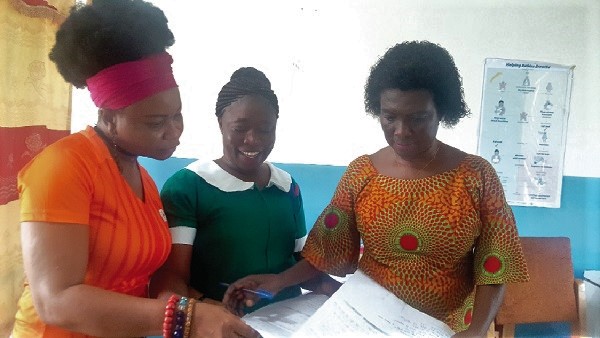 The improvised steriliser, showing instruments ready for sterilisation• Ms Veronica Ofosua Opoku (middle) showing records of maternal births at the health  centre to Ms Esi Awotwi of the UNFPA (left) and Ms Judith Twumasi (right)