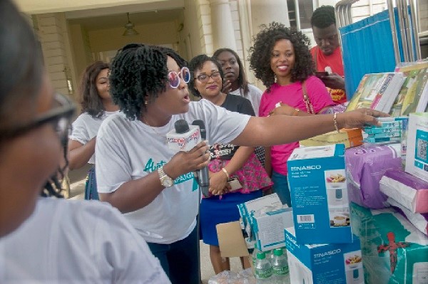  CEO of Genet Services, Mrs Georgina Nettey (left) presents the items