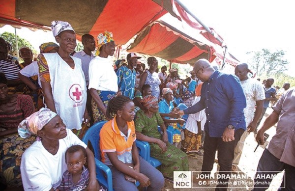 Former President Mahama exchanging pleasantries with the flood victims