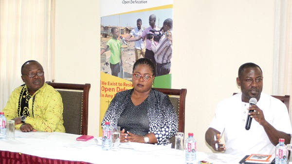 Mr Yaw Atta Arhin (right), WASH Technical Coordinator, speaking at a panel discussion on the proposed National Sanitation Authority in Accra. Those with him are Ms Ama Ofori Antwi (middle) Executive Secretary of Environmental Service Providers Association and Mr Kweku Quansah (left) Deputy Director of the Ministry of Sanitation and Water Resources. 