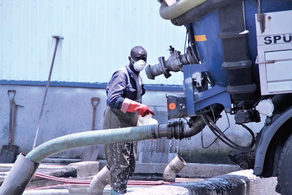  A worker in protective clothing ensuring that a waste truck dislodges hygienically at the waste treatment plant. Picture: EDMUND SMITH-ASANTE
