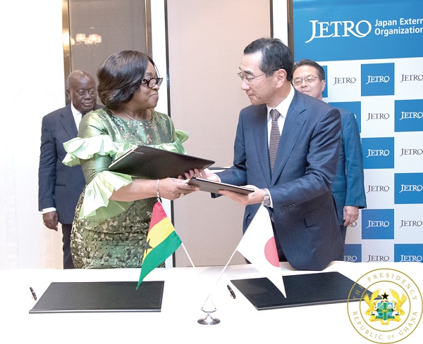 Ms Shirley Ayorkor Botchway (left) exchanging the MoU with Mr Nobuhiko Sasaki, Chairman of JETRO