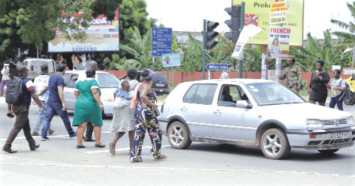 Pedestrains crossing the road in front of the 37 Military Hospital in Accra. 