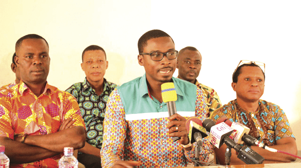 Mr John Ackon (with mic) addressing the news conference. With him are Mr Seth Mawunyegah (right), Chairman; Mr Joseph Kugblenu (left), Vice-Chair, and some other executives of the group.
