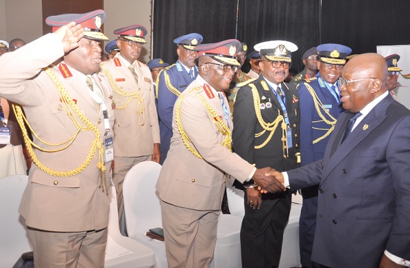 President Nana Addo Dankwa Akufo-Addo exchanging pleasantries with some security chiefs at the Kofi Annan Peace and Security Forum in Accra. Picture: SAMUEL TEI ADANO