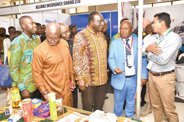  Mr Alan Kyerematen (middle), the Minister of Trade and Industry, interacting with some of the exhibitors during the  opening session of the Ghana Industrial Summit and Exhibition 2019. Others are Mr Yofi Grant (2nd left), and Dr Yaw Adu Gyamfi (2nd right). 
