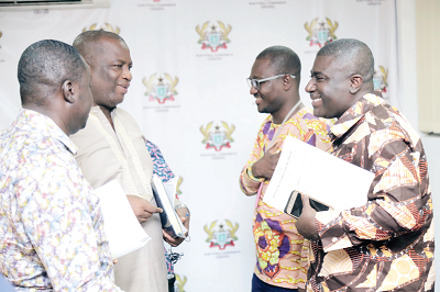 Dr Serebour Quaicoe (2nd left), Director, Electoral Services, interacting with Dr Bossman Eric Asare (right), Deputy Chairman, Corporate Service, EC, and Mr Michael Boadu (left), acting Director Training, EC, after the press briefing.