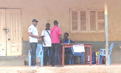 Some voters checking their names at the New Tafo Dichemso Basic School Centre in Kumasi