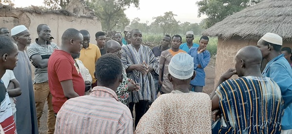 Mr Alhassan S. Dandaawa (in smock) interacting with some of the victims during a visit to Bagurugu