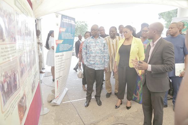 Mr Abraham Otabil (right), Public Relations Officer, Ministry of Lands and Natural Resources, briefing Ms Ama Dokuaa Asiamah Agyei (2nd left), a Deputy Minister of Information, and Mr Kwaku Asomah-Cheremeh, the Minister of Lands and Natural Resources, on some of the projects undertaken by the ministry during an exhibition at the meet-the-press. Picture: EMMANUEL ASAMOAH ADDAI