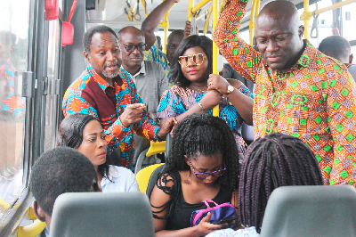 Mr Mohammed Adjei Sowah (right), Mr Daniel Alexander Nii-Noi Adumuah (left), and Mrs Jennifer Dede Adjabeng (2nd  left) interacting with some passengers during the ride on the Ayalolo bus yesterday.  Picture: Maxwell Ocloo