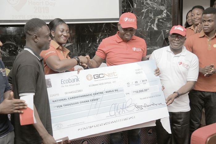  Mrs Akosua Konadu Asamoah (2nd left), Human Resource Manager, GCNet, presenting a dummy cheque to Dr Lawrence Agyeman Sereboe (2nd right), and Dr Abdul-Samed Tankoh (right), Head of the Cardiology Unit, National Cardiothoracic Centre, Ghana, Korle Bu Teaching Hospital. Picture: EMMANUEL ASAMOAH ADDAI  