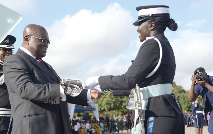  President Akufo-Addo presenting the Overall Best Cadet Officer award to Ms Theodora Ntiriwaa at the 49th Cadet Officers Graduation Parade in Accra. Picture: SAMUEL TEI ADANO