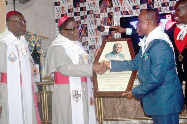  Most Rev. Dr Paul Boafo (lef), Presiding Bishop of the Methodist Church Ghana, on behalf of the church presenting a citation to Mr Kesse (right), the CEO of Kessben Group of Companies