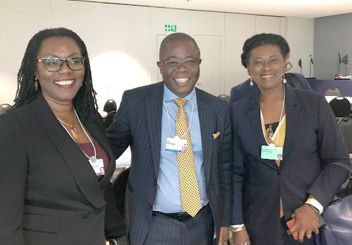  Mrs Ursula Owusu Ekuful  (left) and Mrs Magdalene Apenteng (right) share a moment with Mr Ben Afudego, a participant in the World Economic Forum