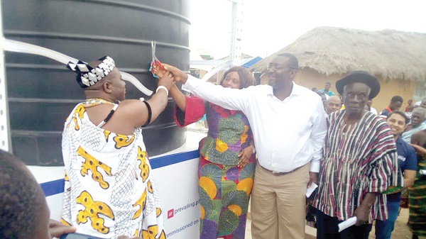  Mr. Ken Arthur, (2nd right) being assisted by Ms Madam Sarah Dugbakie Pobee and Nene Lomo IV, (left)  Divisional Chief of the Lomobiawe Clan of Ada to inaugurate the facility.