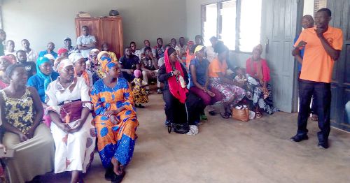 Mr Sumani Bapio Ibrahim (right) addressing some hearing impaired persons