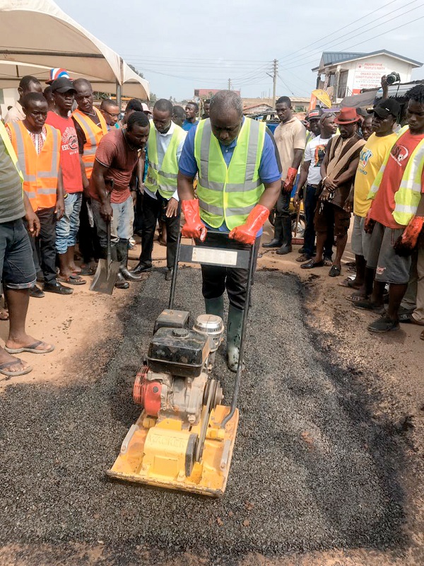 Mr Ahmed Arthur demonstrating the use of the compactor