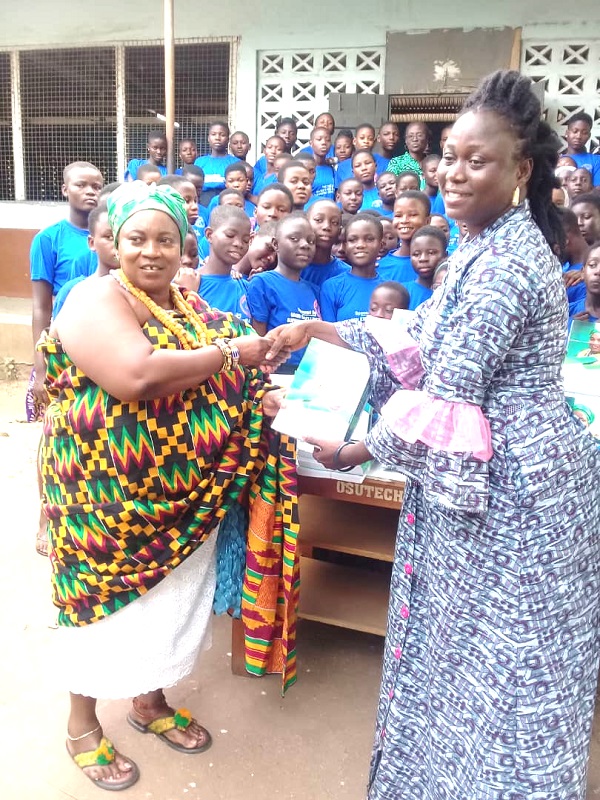  Manye Amponsah Dokua II making a presentation of books and some school supplies to Mrs Alberta Seyram Adjoa Ananga-Ayitey