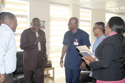 Mr Ekwow Spio-Garbrah (left) interacting with  Mr Ato Afful (3rd right), Managing Director, GCGL;  Mrs Mavis Kitcher (right), Director, News, GCGL; and Mr Kobby Asmah (2nd right) Editor, Daily Graphic, when he visited the company  in Accra. Picture: GABRIEL AHIABOR