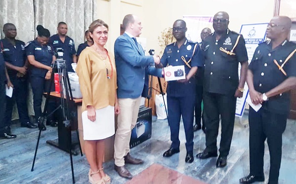 Mr Zoltan Agai handing over the equipment to COP Amponsah Asiamah (in uniform). On the right are some of he equipment