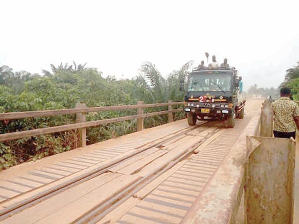 The bridge showing the loose planks and deplorable portions
