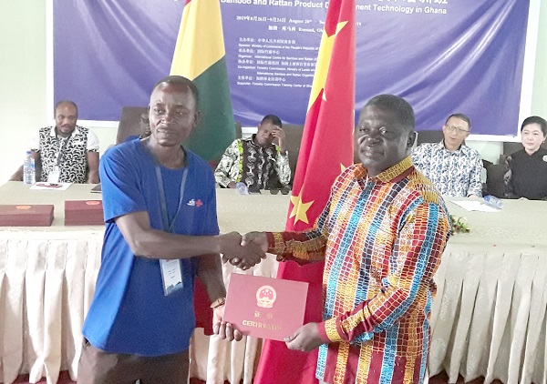 One of the trainees, Samuel Owusu (left), receiving his certificate from Mr Benito Owusu Bio