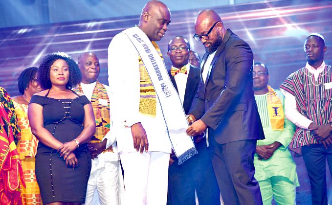 Dr Daniel Mc Korley (right), Chairman of the McDan Group, handing over the mantle to Prof. Abednego Okoe Feehi Amartey as the newly crowned CIMG Marketing Man of the Year. Pictures: EBOW HANSON