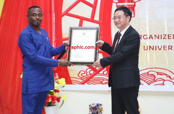 Mr Kwamena Duncan (left) presenting a citation to Prof Hu for his immense contribution to Ghana-China friendship and cooperation.