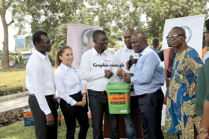 Mr Nana Yaw Ampem-Darko Antwi (middle) presenting some items to Mr Mohammed Adjei Sowah (right) during the launch of the ‘Accra for Arts Initiative’. Picture:ESTHER ADJEI