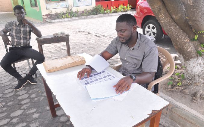  Exhibition officials of the Electoral Commission sitting idle waiting for voters to have their names checked at some centres visited at  Adabraka in Accra. Picture: SAMUEL TEI ADANO