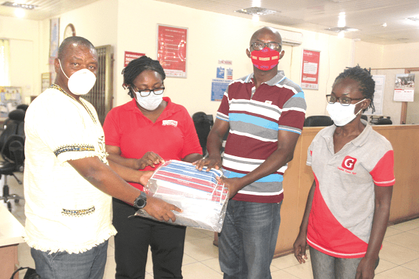 Mr Wisdom Peter Awuku (left) presenting the items to Mr Albert Salia (2nd right), acting Political Editor, Daily Graphic during the event. With them are some members of the editorial team. Picture: EDNA SALVO-KOTEY