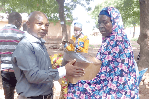 Mr Ras Mubarak (left) presenting one of the gift boxes to a beneficiary at Dalun