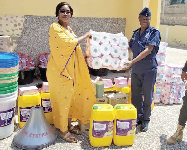 Mrs Cynthia Morrison (left), presenting the items to DSP George Adanye of the Swedru Divisional Police Command