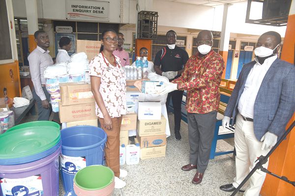  Mr Kwabena Agyei-Boahene (2nd right) presenting one of the items to Dr Maame Yaa Nyarko of the hospital,  in Accra on Tuesday