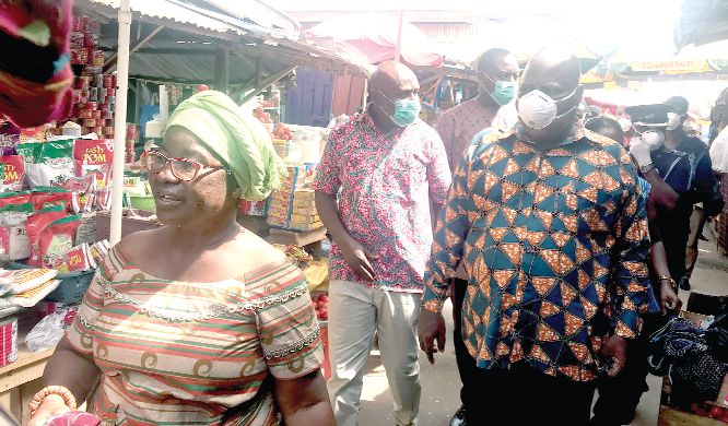 Mr Ishmael Ashitey (right), Greater Accra Regional Minister inspecting the Nungua market during the visit