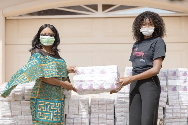 Mrs Cynthia Morrison (left), Minister of Gender, Children and Social Protection, receiving the ‘Sincerely’ sanitary pads from Ms Ruth Quarshie, a representative of Sincerely Ghana Limited, and Miss Universe Ghana 2017