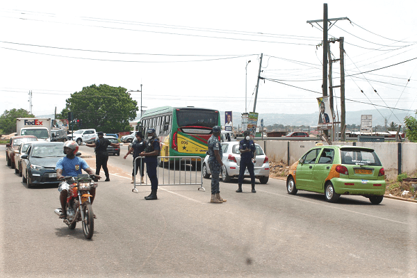 Some police personnel manning their post at the Adenta barrier during the lockdown. Picture: Maxwell Ocloo