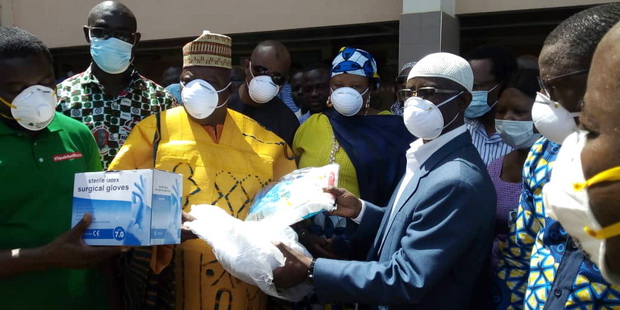 Alhaji Ibrahim Mobila (left), Northern Regional Chairman of NDC handing over the PPE to Dr Mumuni (right ), acting CEO of TTH