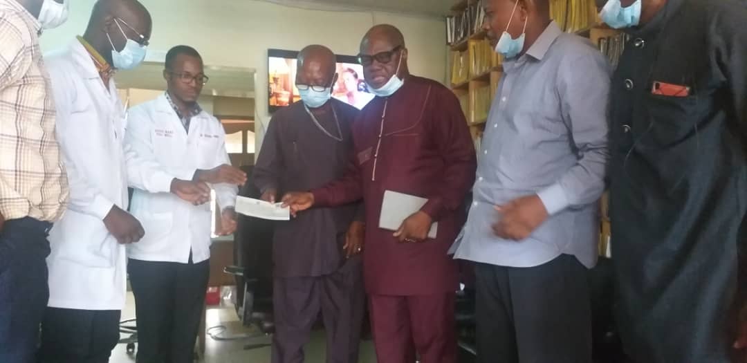 Chief Bishop of FEMW, Frederick France (3rd right), presenting a cheque for GH 50 million to the Medical Director of FEM Hospital, Dr Raphael Kwasi Tufuor (2nd left).