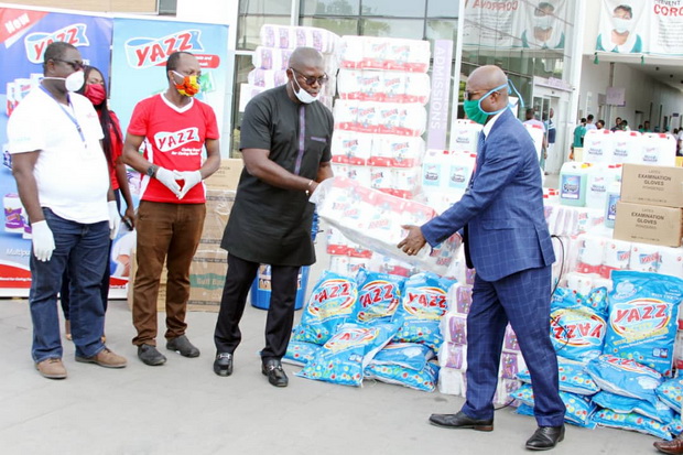 Mr Martin Brobby (3rd left) Managing Director of Lexta Ghana Limited presenting the items to Dr. Emmanuel Srofenyo (right), Medical Director of the Greater Accra Regional Hospital.