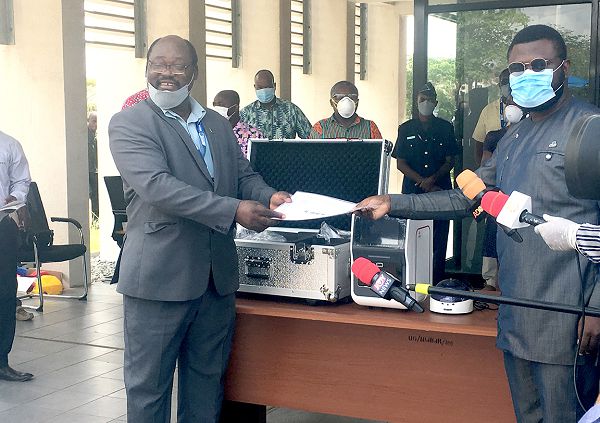 Prof. Abraham Kwabena Annan (left) receiving the testing equipment from Mr Gregory Rockson (right)